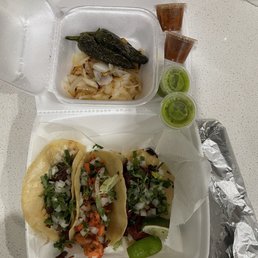 Steak fajita, chicken fajita, and barbacoa tacos, plus a bean and cheese burrito.