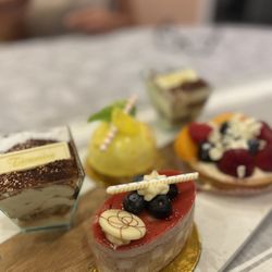 Sorrento Bakery - Blueberry mousse cake up close, tiramisu, fruit tart, lemon mousse cake