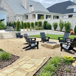 Backyard design featuring rock landscape with firepit and seating area, privacy trees, focal, accent and ornamental plants