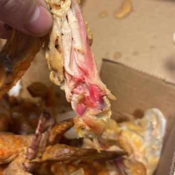 Yoli's Cucina and Crafthouse - a person picking up a piece of food from a box - Italian Near Me - Jefferson Hills, Pennsylvania