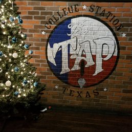 a christmas tree in front of a brick wall a christmas tree in front of a brick wall