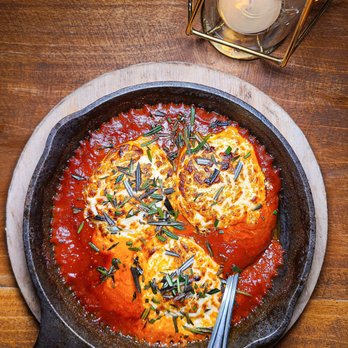 Pizzette - a skillet filled with tomato sauce and cheese - Pizza Near Me - Miami Beach, Florida