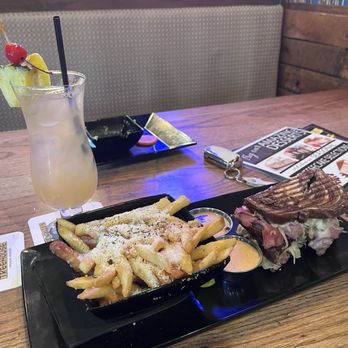 Crazy Craig's Treehouse - Ruebens Revenge Panini and  Dressed Garlic Parm Fries Large - American Near Me - Branson, Missouri