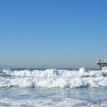 Manhattan Beach Pier - High surf at the pier - surfer at far left. - Local Flavor Near Me - Manhattan Beach, California Manhattan Beach Pier - High surf at the pier - surfer at far left. - Local Flavor Near Me - Manhattan Beach, California