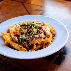 Triangle Tavern - Bacon Cheese Fries - Crinkle fries with nacho cheese topped with bacon crumbles, shredded cheddar jack cheese, green onions and sour cream