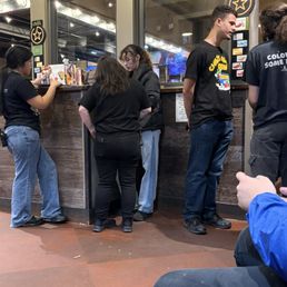 Employees standing around gossiping.