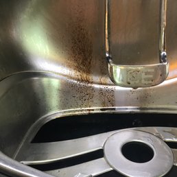a dirty sink with a metal faucet a dirty sink with a metal faucet