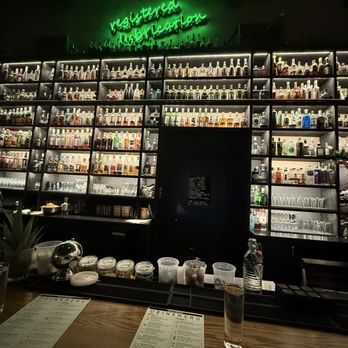Dram and Draught - beautiful bottle wall - Cocktail Bars Near Me - Raleigh, North Carolina