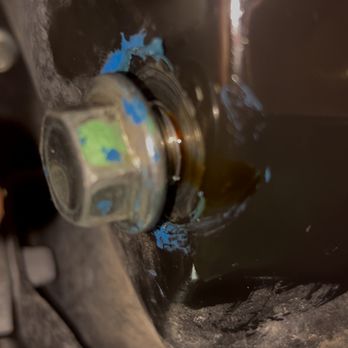 Nexcar - Oil pan covered in blue silicon with the plug threaded until reaching the damaged threads. - Used Car Dealers Near Me - Spring, Texas