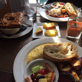 SoBo Kitchen & Bar - Saturday brunch menu:  Top: Shakshuka Left: Chicken Pot Pie Bottom: House Smoked Salmon Omelet Midde: Lemon cake (provided) - American Near Me - Baltimore, Maryland