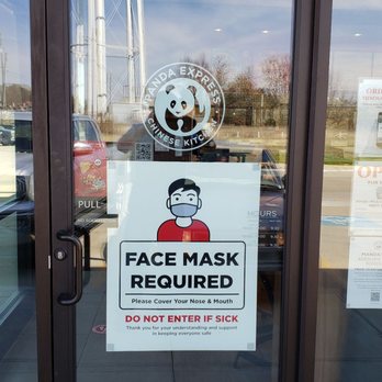 Panda Express - Big sign says come in with mask.  A little sign says you can get curb side or to go but nothing says there is no dine in. - The glass door displays signs about face mask requirements and COVID-19 safety protocols, including a panda logo and operational hours. - Chinese Near Me - Kaufman, Texas