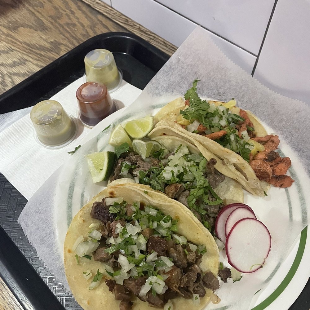 Front: Lengua (Beef Tongue) Taco, middle: Carne Asada Taco, back: Al Pastor Taco Front: Lengua (Beef Tongue) Taco, middle: Carne Asada Taco, back: Al Pastor Taco