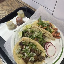 Front: Lengua (Beef Tongue) Taco, middle: Carne Asada Taco, back: Al Pastor Taco Front: Lengua (Beef Tongue) Taco, middle: Carne Asada Taco, back: Al Pastor Taco