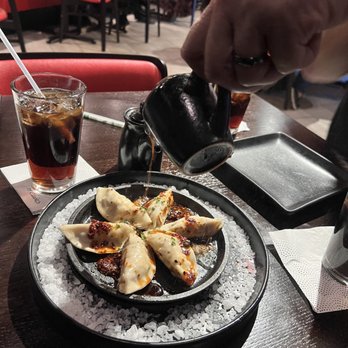 P.F. Chang's - The potstickers came with a sauce that you pour over them, on the sizzling hot plate. It was fun!  And delicious! - Chinese Near Me - Orem, Utah