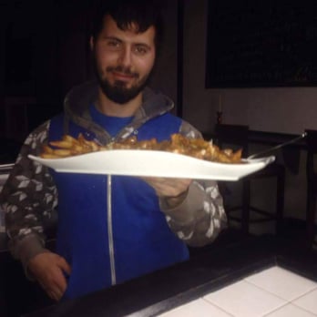 Café Hold'Em - a man holding a plate of food - Cafes Near Me - Montreal, Quebec