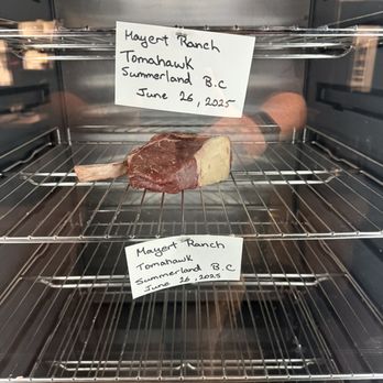 Orolo - Steak fridge with tomahawk steaks. - Cocktail Bars Near Me - Penticton, British Columbia