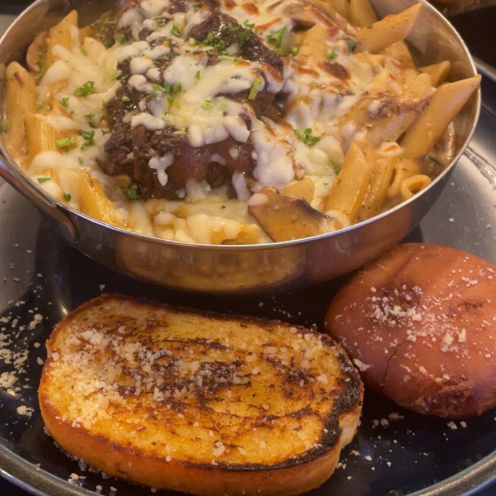 Godfreys - Oxtail pasta comes with a yeast roll and garlic bread - Caribbean Near Me - Flowood, Mississippi