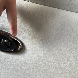 Casimia delivery guy/installer pointing out the 2nd blemish (pin hole) that I found and they pretended like they didnt see.