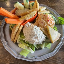 Momma Rabbit's Nibbles and Sips - The Trifecta, with chicken salad l, Pimento cheese, and fresh hummus on a bed of romaine with toasted pita points