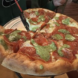 Pepperoni pizza with pesto sauce Pepperoni pizza with pesto sauce