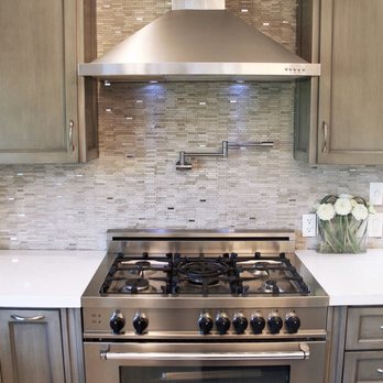 Venetian Builders - Our gas stove with stainless steel hood and tiled backspash (the white countertops were the perfect choice) - General Contractors Near Me - Van Nuys, California Venetian Builders - Our gas stove with stainless steel hood and tiled backspash (the white countertops were the perfect choice) - General Contractors Near Me - Van Nuys, California