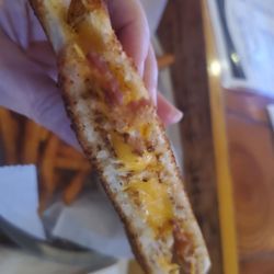 Satch's Bar and Grill - Cross section of grilled cheese with added bacon.