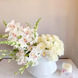 Esmé Flowers - Premium all white arrangement of cymbidiums orchids and white roses in a gorgeous ceramic vase.