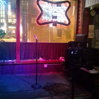 Mikey's Pub - a microphone in front of a window - Pubs Near Me - Green Bay, Wisconsin