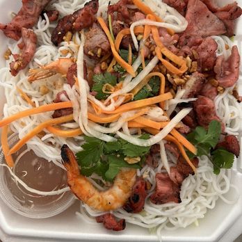 Cafe Da Lat - Pork and shrimp - A Vietnamese-style noodle dish with rice noodles, shrimp, grilled meats, shredded carrots, bean sprouts, cilantro, and a side of dipping sauce in a foam container. - Vietnamese Near Me - Albuquerque, New Mexico