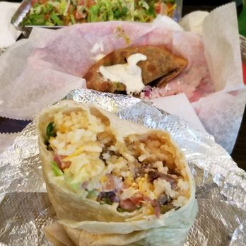 Frijolito's - Steak burrito in foreground. Authentic bean pouch in the background. - Mexican Near Me - New York, New York Frijolito's - Steak burrito in foreground. Authentic bean pouch in the background. - Mexican Near Me - New York, New York