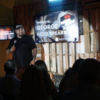 Rose City Comedy - a man standing on stage in front of a crowd - Comedy Clubs Near Me - Tyler, Texas Rose City Comedy - a man standing on stage in front of a crowd - Comedy Clubs Near Me - Tyler, Texas