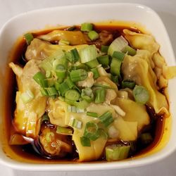 Eastern Pavilion - Wontons in Chili Oil. Tender tiny pork wontons in a spicy chili oil, with scallions, garlic, and a little black vinegar. Very good.