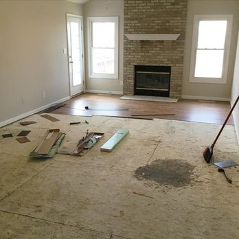 Gomez Flooring - a room with a fire place and a fireplace - Flooring Near Me