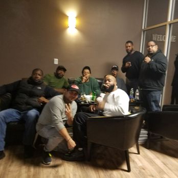 The Cave Cigar Lounge - a group of men sitting around a table - Cigar Bars Near Me - Newark, New Jersey The Cave Cigar Lounge - a group of men sitting around a table - Cigar Bars Near Me - Newark, New Jersey