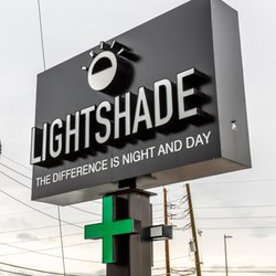 Lightshade Rec & Med Dispensary - Lightshade dispensary sign with the tagline "The Difference is Night and Day" and a green cross symbol.