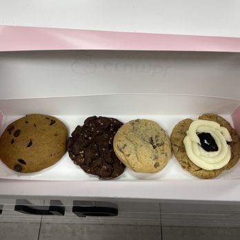 Crumbl - Oak Creek - Left to right: Pumpkin chocolate chip, chocolate peanut butter chip, classic chocolate chip, blueberry cheesecake. - Bakeries Near Me - Oak Creek, Wisconsin