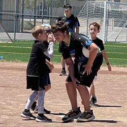 Esporterz - Campers "strategizing" with our coach to win the kickball game. Outdoor games all summer long