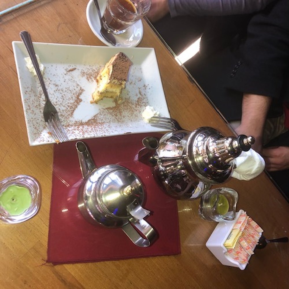Pot of black tea with mint and a delicious tiramisu Pot of black tea with mint and a delicious tiramisu