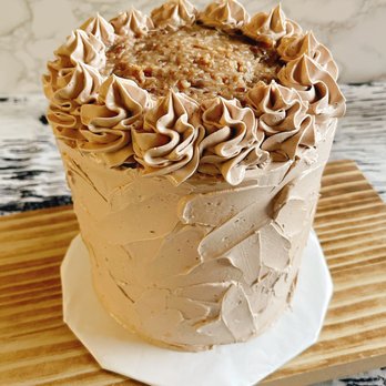 KK's Bakes by Kynda Knight - a frosted cake on a wooden board - Custom Cakes Near Me KK's Bakes by Kynda Knight - a frosted cake on a wooden board - Custom Cakes Near Me