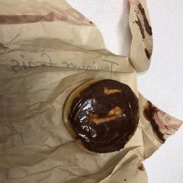 a chocolate donut on a piece of paper a chocolate donut on a piece of paper