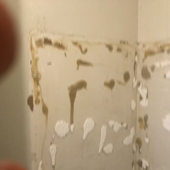 One Above Legacy - a dirty bathroom with moldy walls - Handyman Near Me