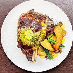Jason Raffin Maui Private Chef - Tomahawk steak with roasted vegetables and herb butter--crafted by a Maui private chef for unforgettable dinner parties.