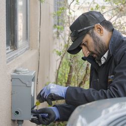 Signature Heating, Cooling & Plumbing - Signature HVAC Tech, working on power box to condenser