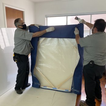 Craters And Freighters - Francisco and Ruben wrapping up the painting to transport to their warehouse where it will be crated for shipping. - Shipping Centers Near Me - San Jose, California