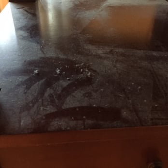 The Green Company - bottom shelf of dining room table... the worst part is that she did clean the top of it. - Office Cleaning Near Me - Detroit, Michigan
