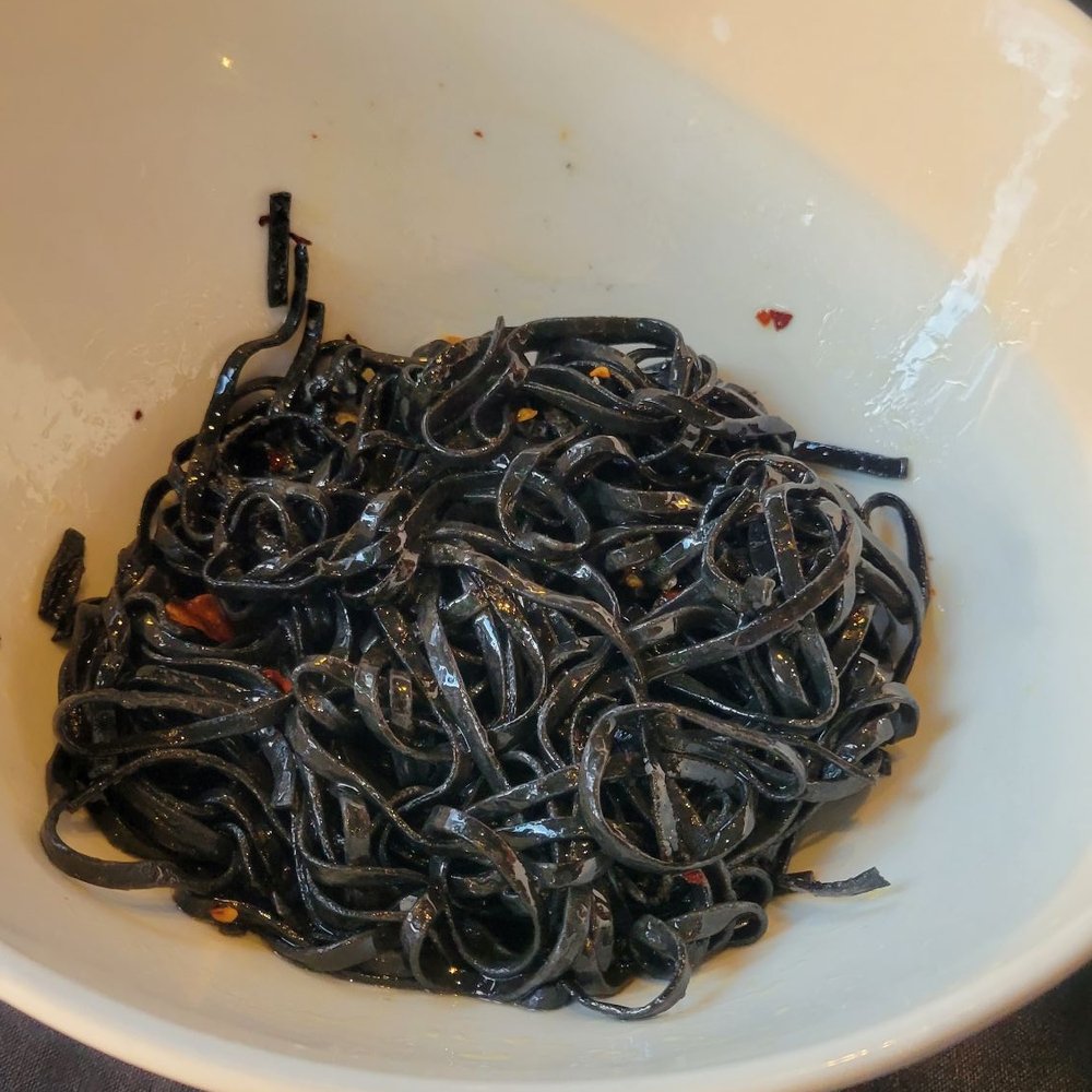 The Beacon - Cacia e pepe - squid ink pasta in a crispy garlic olive oil sauce and crushed red pepper - New American Near Me - Petoskey, Michigan The Beacon - Cacia e pepe - squid ink pasta in a crispy garlic olive oil sauce and crushed red pepper - New American Near Me - Petoskey, Michigan