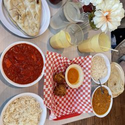 Dino Buffet and Bar - Chicken Tikka Masala, Butter Chicken, 2 orders of Naan, what's left the Vegetable Pakoras and a Mango Lassi we split!