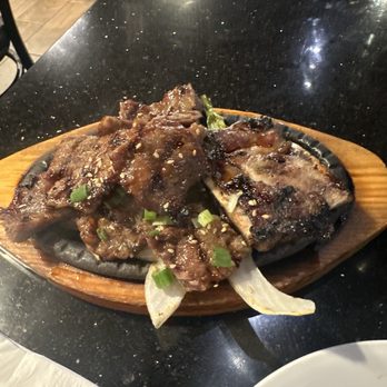 Jong Ga House - Hmmmm ! Fatty long bone sliced beef galbi sizzling away with onions on the bottom. - Korean Near Me - Oakland, California