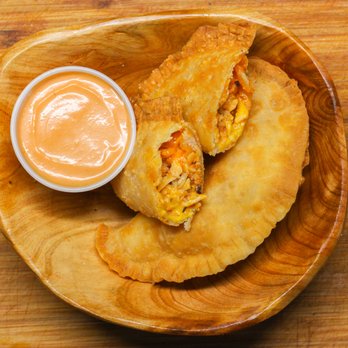 Tripleta Pollo Loky - a wooden plate with a small bowl of sauce - Food Trucks Near Me Tripleta Pollo Loky - a wooden plate with a small bowl of sauce - Food Trucks Near Me