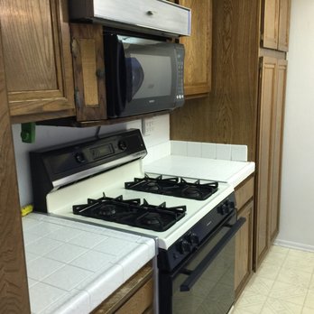 EXTREME PAINTING - a kitchen with a stove and microwave - General Contractors Near Me - Huntington Beach, California